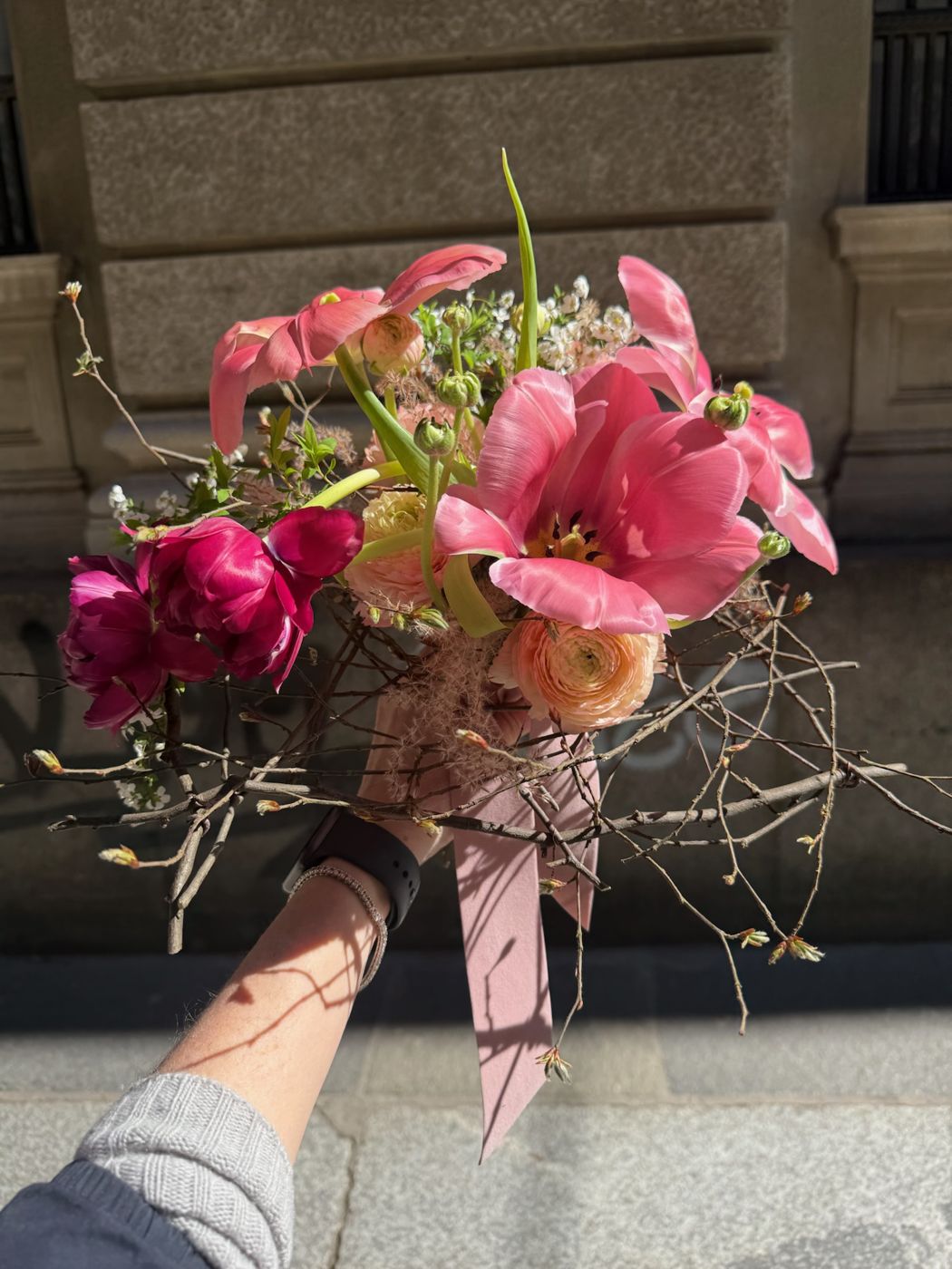 Bouquet rosa tenuto in mano per strada